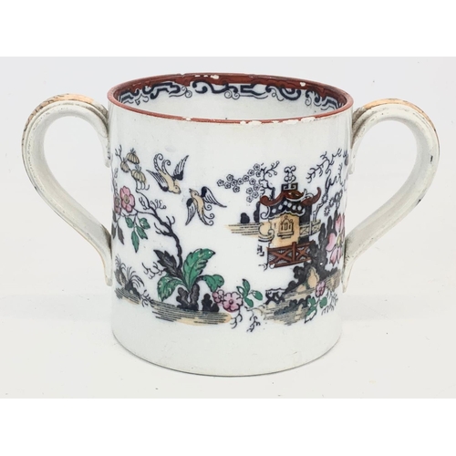 467 - A Victorian pottery loving cup. 22 x 12.5cm.