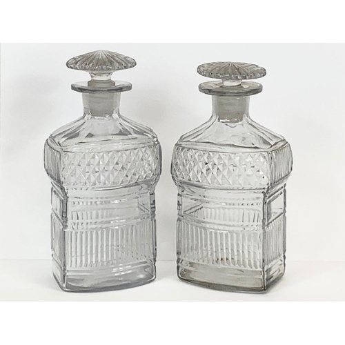 473 - A pair of late 19th century cut glass decanters. 17cm