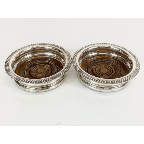 503 - A pair of sterling silver wine bottle coasters. Chester 1919. 15cm