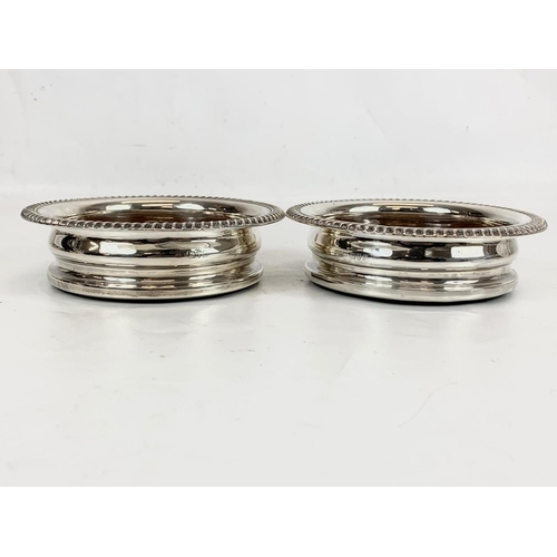 503 - A pair of sterling silver wine bottle coasters. Chester 1919. 15cm