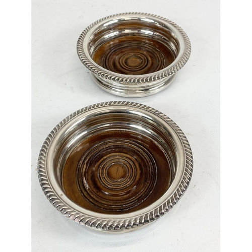 503 - A pair of sterling silver wine bottle coasters. Chester 1919. 15cm