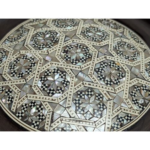 774 - A wooden Mother of Pearl inlaid plaque. 25cm