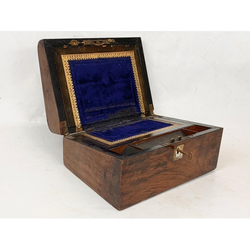 79 - A Victorian walnut writing box with key and mother of pearl inlay. Closed 30 x 22 x 15cm