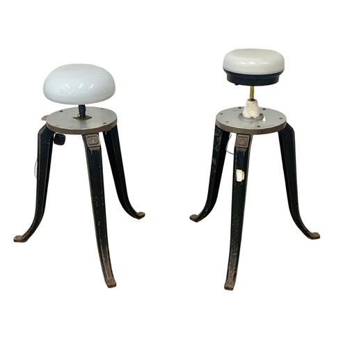 797 - A pair of early 20th century industrial cast iron stool bases converted into lamps. 93cm