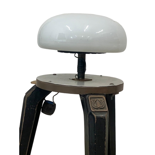 797 - A pair of early 20th century industrial cast iron stool bases converted into lamps. 93cm