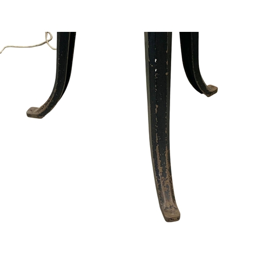 797 - A pair of early 20th century industrial cast iron stool bases converted into lamps. 93cm