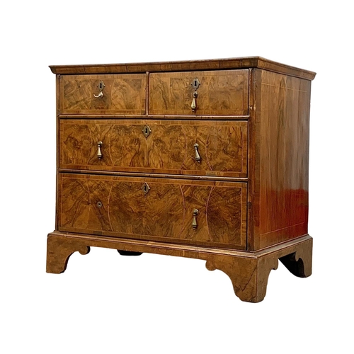 798 - An original early 18th century George I inlaid walnut chest of drawers, in bracket feet. Circa 1720.... 