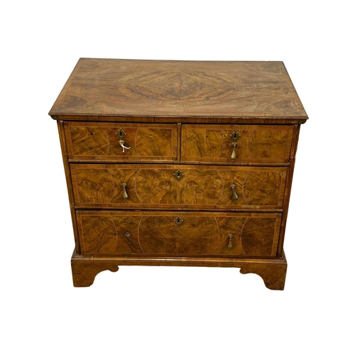 798 - An original early 18th century George I inlaid walnut chest of drawers, in bracket feet. Circa 1720.... 