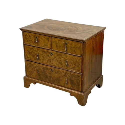 798 - An original early 18th century George I inlaid walnut chest of drawers, in bracket feet. Circa 1720.... 