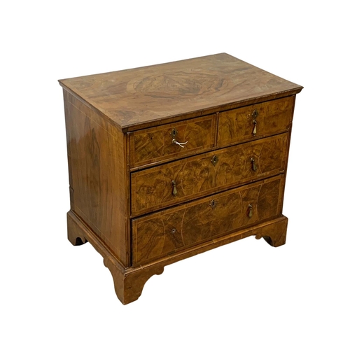 798 - An original early 18th century George I inlaid walnut chest of drawers, in bracket feet. Circa 1720.... 