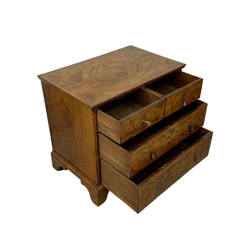 798 - An original early 18th century George I inlaid walnut chest of drawers, in bracket feet. Circa 1720.... 