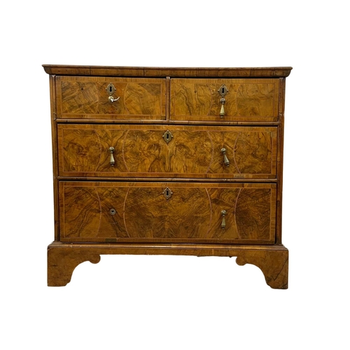 798 - An original early 18th century George I inlaid walnut chest of drawers, in bracket feet. Circa 1720.... 