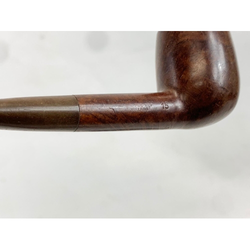 94 - A quantity of vintage smokers pipes on stand. Mostly by Peterson’s of Ireland. 1 silver mounted. Sta... 