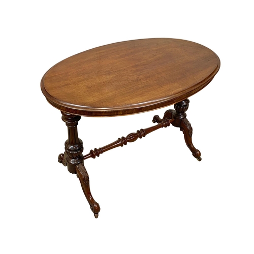 1132 - A Victorian mahogany library table on carved double pedestal base, 105cm x 65 x 75cm