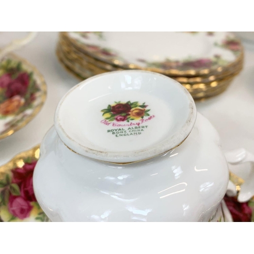 443 - A 23 piece Royal Albert Old Country Roses tea set. 6 cups, 6 saucers, 6 sandwich plates, cake dish e... 