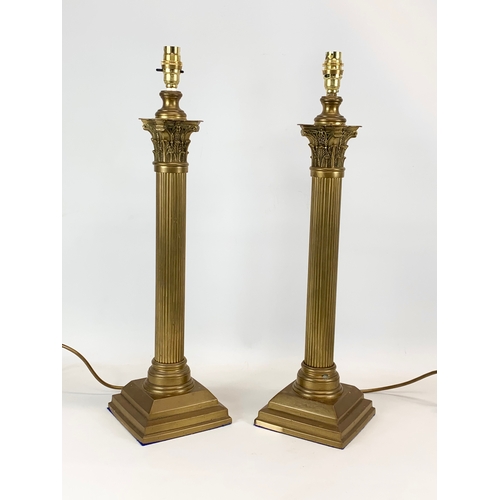 86 - A pair of large brass table lamps with Corinthian style pillars. 58cm.