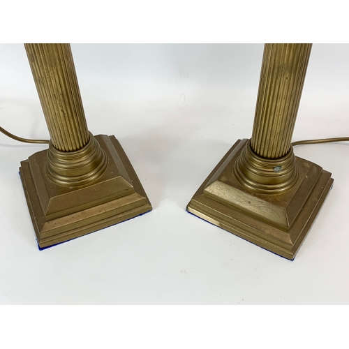 86 - A pair of large brass table lamps with Corinthian style pillars. 58cm.