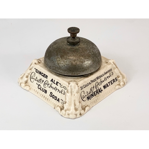 87 - An early 20th century pottery advertising shops bell. 10 x 7cm