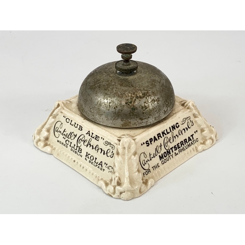 87 - An early 20th century pottery advertising shops bell. 10 x 7cm