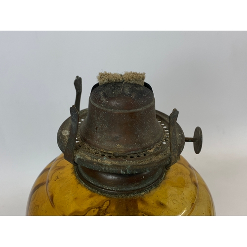 89 - A Victorian amber glass oil lamp. 47.5cm