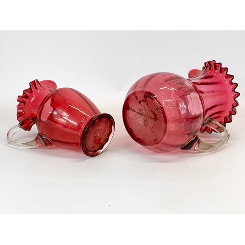 449 - 2 Victorian Ruby Glass jugs. Largest 18 x 22cm