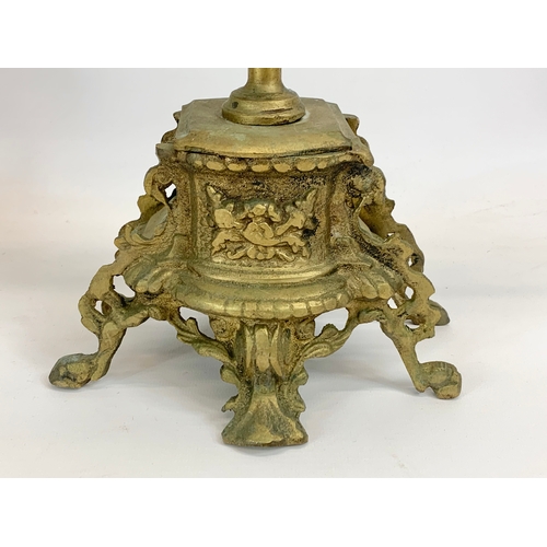 111 - A large 18th century style heavy brass clock set. Clock and a pair of candelabras. Clock measures 32... 