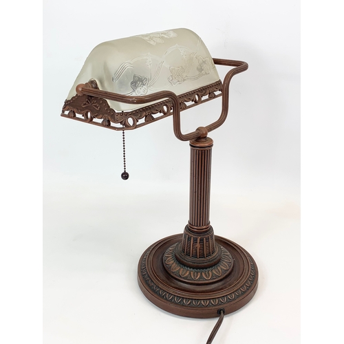 112 - A Lalique style faux bronze desk lamp, with frosted glass shade. 26 x 38cm