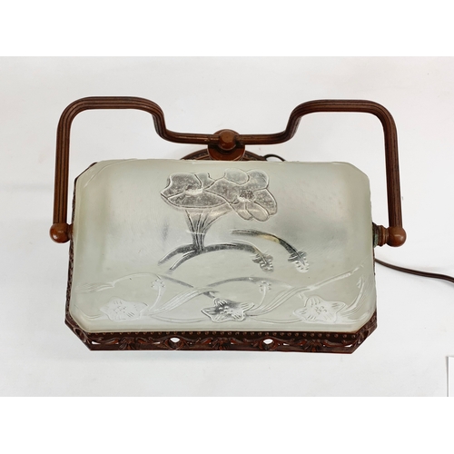 112 - A Lalique style faux bronze desk lamp, with frosted glass shade. 26 x 38cm