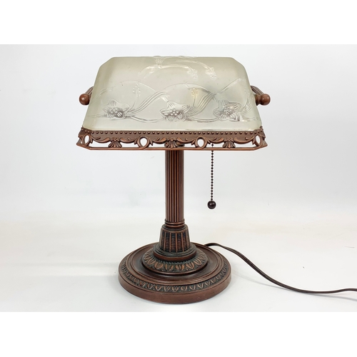 112 - A Lalique style faux bronze desk lamp, with frosted glass shade. 26 x 38cm