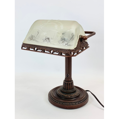 112 - A Lalique style faux bronze desk lamp, with frosted glass shade. 26 x 38cm