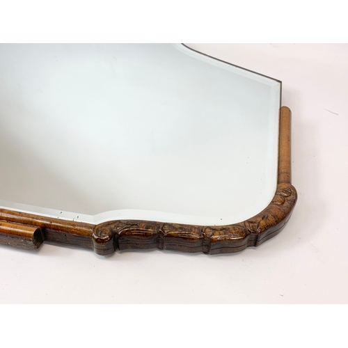 121 - An early 20th century Art Deco bevelled mirror. 72 x 41cm