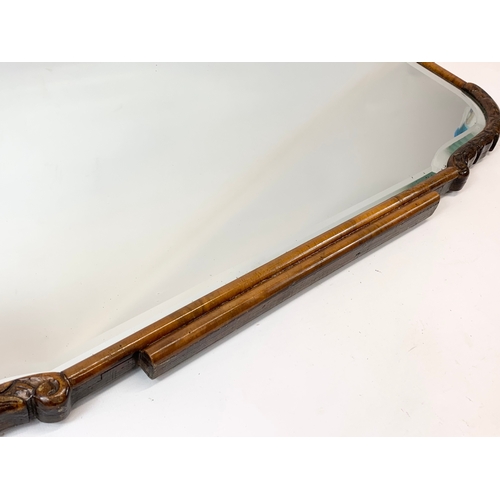 121 - An early 20th century Art Deco bevelled mirror. 72 x 41cm