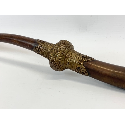 138 - An early 20th century Tibetan brass Sea Dragon Ritual Blessing Horn. 52cm