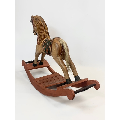 169 - A small wooden rocking horse. 61 x 43cm.