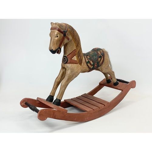 169 - A small wooden rocking horse. 61 x 43cm.