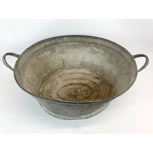 197 - A large early 20th century galvanised tub with 2 handles. 73 x 50 x 32cm.