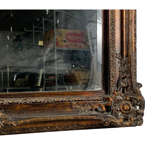 214 - A large ornate framed mirror. Model “Bodium Bronze Crackle” 102 x 127cm