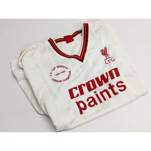 256 - 2 Liverpool tops. White top is a size Large. Red top is a size Extra Large.