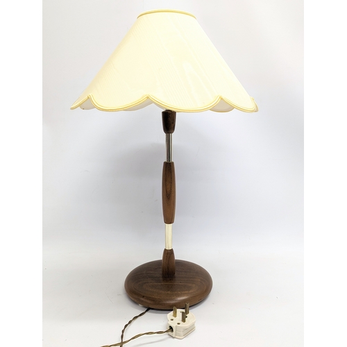 246 - A Mid Century teak lamp. 59cm including shade.