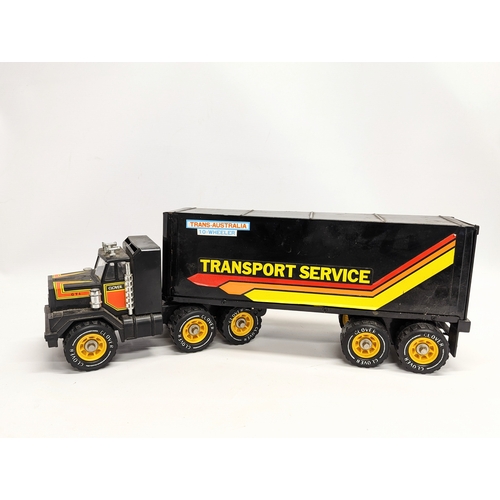 265 - 3 toys including a 1986 Remco Big Rig Towing truck, a Trans-Australia 10-wheeler made by Clover Toys... 