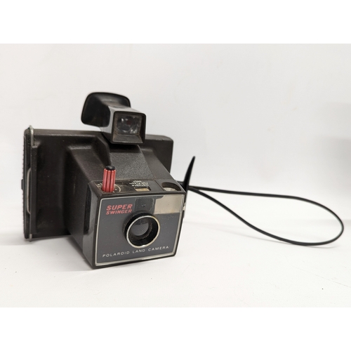 267 - A quantity of vintage cameras, accessories with a vintage Phillips tape recorder. Cameras includes a... 