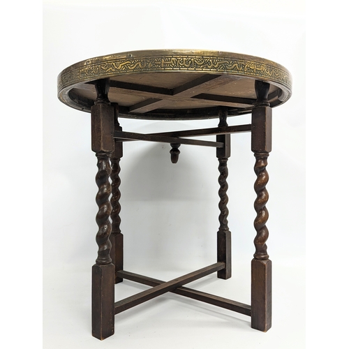 263A - An early 20th century folding brass top table. Top measures 59.5cm.