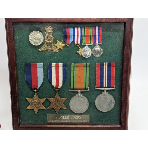 279 - A framed case of World War II medals of James Anderson, Pioneer Corps, with a quantity of military e... 