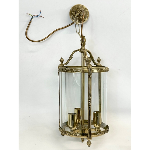 299 - A set of 3 matching ornate brass light fittings with glass panels. 20 x 58cm including chain.