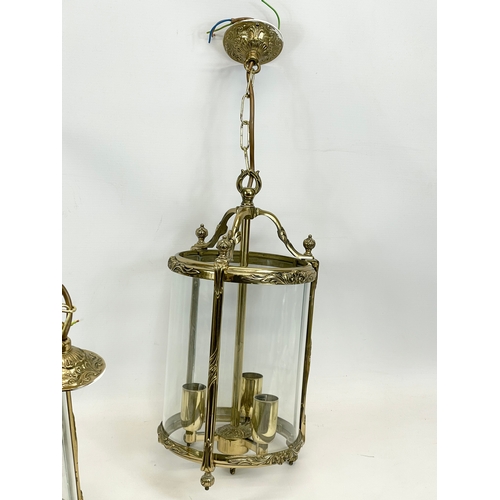 299 - A set of 3 matching ornate brass light fittings with glass panels. 20 x 58cm including chain.