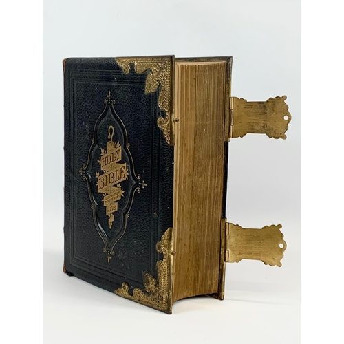 11 - A large late 19th century leather brass bound Holy Bible. 28 x 10 x 34cm