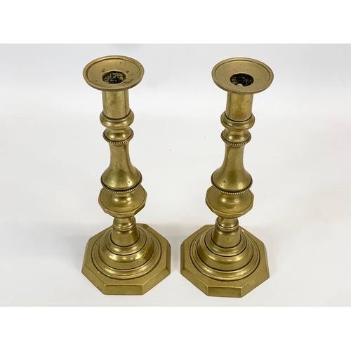 400 - A pair of Victorian brass candlesticks. 27cm