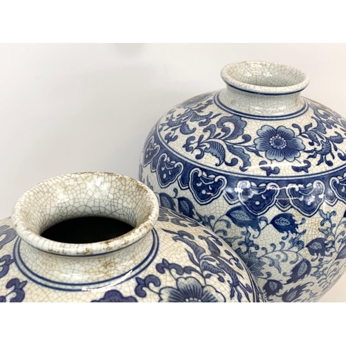 415 - A pair of large vintage Chinese blue and white pottery vases. 26 x 36cm