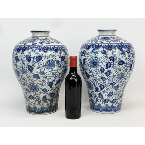 415 - A pair of large vintage Chinese blue and white pottery vases. 26 x 36cm