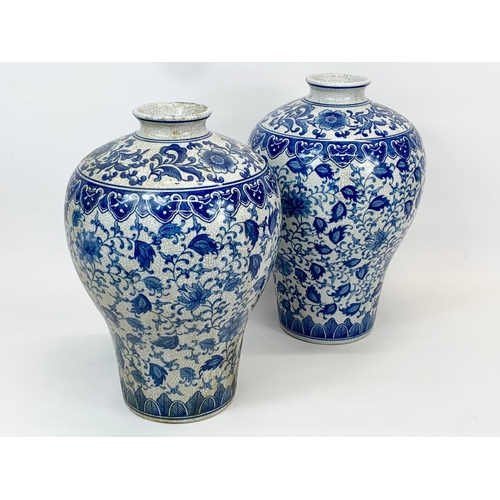 415 - A pair of large vintage Chinese blue and white pottery vases. 26 x 36cm